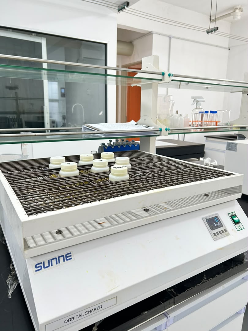 Labelled sample vessels on a laboratory orbital shaker